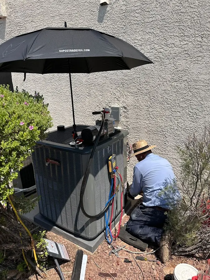 HVAC technician performing outdoor AC maintenance in Deerpark