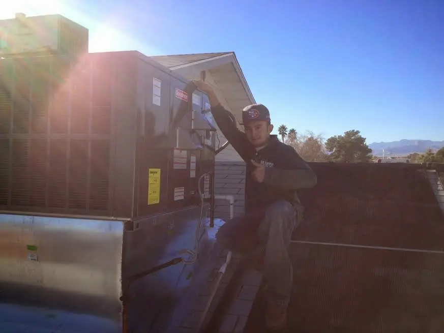HVAC technician performing Boiler Repair on a rooftop unit in Deerpark